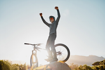 Mountain bike winner or motorcycle man with success, yes or fist pump for fitness achievement goal or motivation outdoor and blue sky mockup. Sports person winning with adventure bicycle on a hill