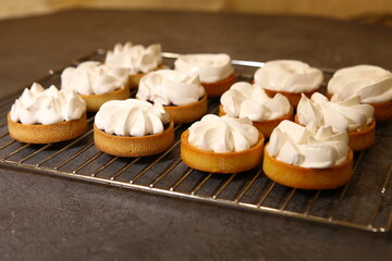 The tart cooking process, dessert in the oven, baking of tarts. Side view, top view. Professional dessert-making process, before baking.