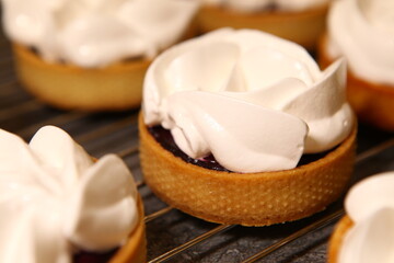The tart cooking process, dessert in the oven, baking of tarts. Side view, top view. Professional dessert-making process, before baking.