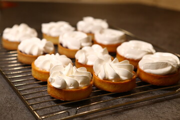 The tart cooking process, dessert in the oven, baking of tarts. Side view, top view. Professional dessert-making process, before baking.