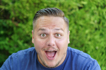 Young man gawping at the camera with mouth open