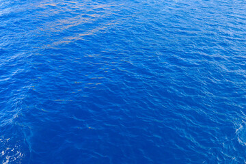 Very nice sea water background or backdrop with selective focus. Small waves of natural water surface texture.