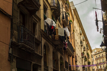 Barcelona street with washing hanging from balcony to dry and air
