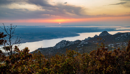 Colors of fall in deciduous forest between rocks and stones. Colorful autumn nature in national park in Paklenica National Park Croatia. Cold weather foggy river. Croatian nature in mountains. Nobody.