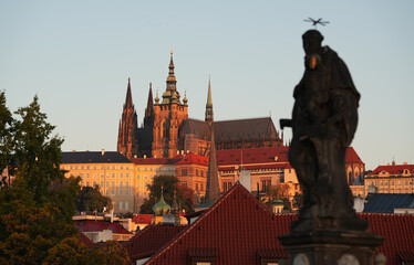 Naklejka premium Sunrise over Prague Castle and Saint Vitus Cathedral, amazing warm autumn light early in the morning. Travel to Czech republic.