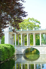 Obraz premium Royal Palace on the Water in Lazienki Park, Warsaw. Bridge to the Palace of the Royal Baths in Warsaw, the capital of Poland.