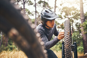 Cycling, adventure trail and bike repair, man fix wheel in forest. Nature, mountain biking and cyclist, outdoor cycle maintenance in Australia. Bicycle ride, dirt path and biker stop for tyre change.
