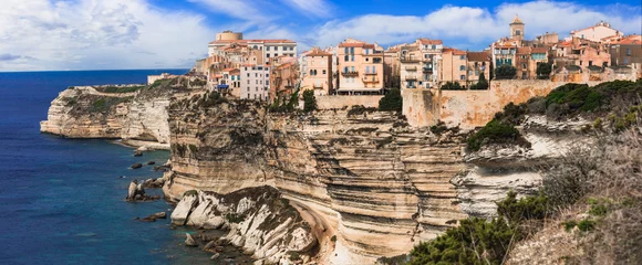 Poster Bonifacio - splendid coastal town  in south of Corsica island, aerial drone view of houses hanging over rocks. France © Freesurf