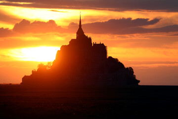 breathtaking silhouette of the abbey of Mont Saint Michel in France at sunset