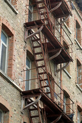 Fototapeta na wymiar old iron staircase for the emergency exits of an industrial building
