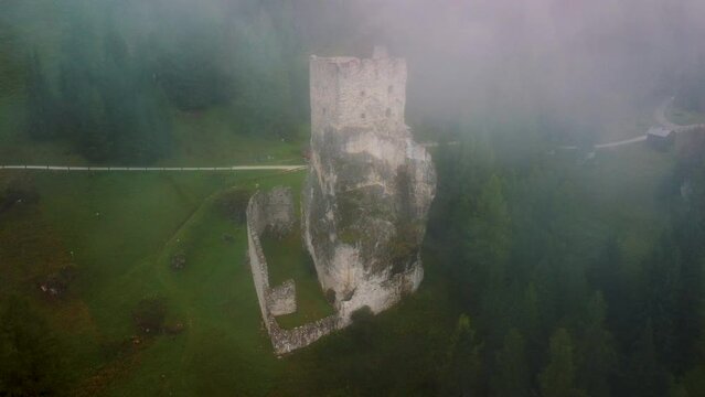 Old castle ruins in the fog, north of Italy, Castello di Andraz.