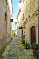 Fototapeta na wymiar A narrow street between the old stone houses of Pizzone, a medieval village in the Molise region of Italy.