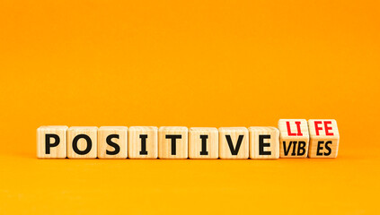 Positive vibes and life symbol. Concept words Positive vibes or Positive life on wooden cubes....