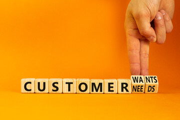 Customer wants and needs symbol. Concept words Customer wants or Customer needs on wooden cubes. Businessman hand. Beautiful orange background. Business customer wants or needs concept. Copy space.