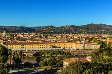 Fototapeta na wymiar Florence, Italy. Scenic view of the Arno River and the city against the backdrop of the surrounding mountains