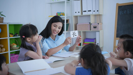 (Chinese wording translation:insect) Educational concept of 4k Resolution. The teacher is teaching children to learn Chinese in the classroom.
