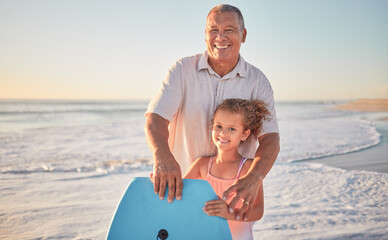 Beach, grandfather and girl learning to surf from a happy senior man in her family on a summer...