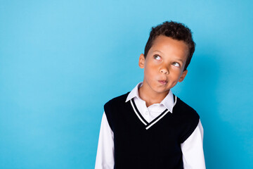 Photo of ponder pensive little guy dressed black vest looking empty space isolated blue color background