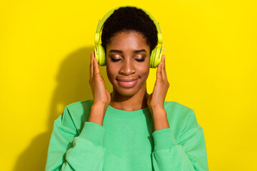 Photo of charming cute short hair person dressed casual pullover enjoying music isolated yellow color background