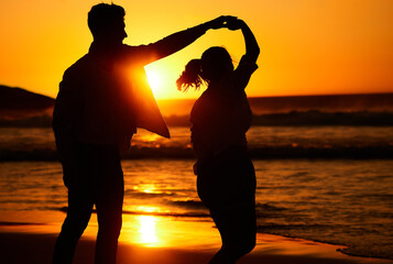 Sunset, dance and silhouette of couple by the beach together for love, travel and Puerto Rico holiday. Summer, sunrise and nature with man and woman dancing by the sea for vacation, happy and relax