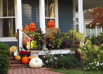 Halloween Jack o' Lanterns Await Treat or Treaters on Front Porch of Building Decoration of Pumpkins
