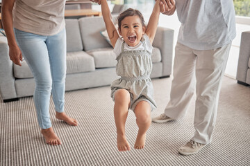 Happy child jump on carpet with grandparents holding hands for support, love or care in living...