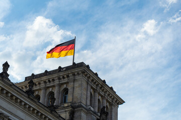 Fototapeta na wymiar German flag waiving on Reichstag, Berlin Germany.