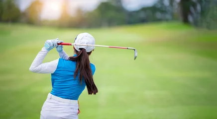 Tuinposter Professional woman golfer teeing golf in golf tournament competition at golf course for winner.  © APstudio