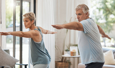 Senior couple, exercise and fitness during aerobics or yoga workout in the lounge at home for...