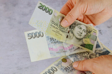 Czech Republic banknotes with man holding Czech koruna CZK bill counting it