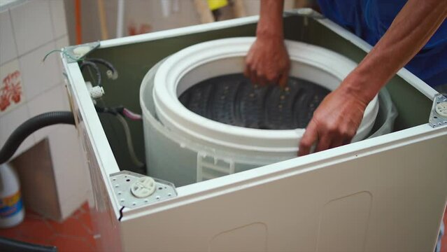 man trying to fix washing machine