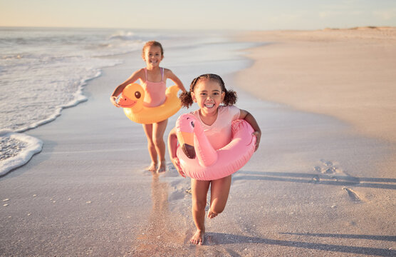 Girls running, kids and beach holiday, vacation or summer trip in Mexico. Travel, portrait and children on sandy ocean sea shore having fun, excited and happy smile together trying to catch waves.