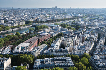 Naklejka premium Panoramic view from second floor of Eiffel tower in Paris. View of the buildings, parks with historical Monmartre on the background