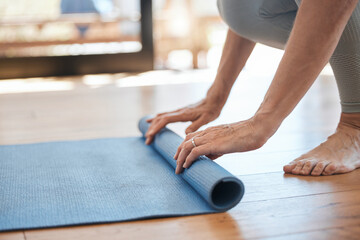 Yoga, hands and woman rolling mat in fitness studio to start workout and meditation. Gym, pilates and meditating for health and mindfulness. Relax, calm and zen, exercise mental health and wellness.