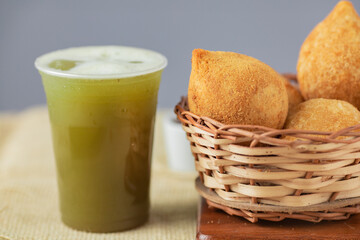 Traditional brazilian snack. Coxinha of chicken and cane juice.
 - obrazy, fototapety, plakaty