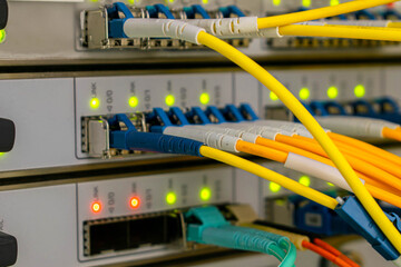 Fiber optic telecommunication cables are connected to the interfaces of the central router.
