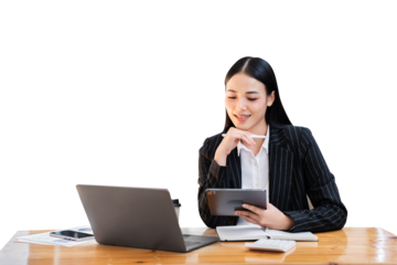 Beautiful Asian business woman typing laptop and tablet Placed at the table at the office. PNG