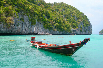 Panorama of thai traditional wooden longtail boat and beautiful sand beach in Krabi province. Traditional Thai boats near the beach. Thailand
