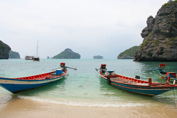 Fototapeta na wymiar Panorama of thai traditional wooden longtail boat and beautiful sand beach in Krabi province. Traditional Thai boats near the beach. Thailand 