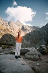 Girl in the mountains. A Caucasian woman is hiking. Concept of adventures in mountains.