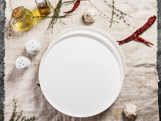 Empty white round plate. Top view. Linen tablecloth. Copy space.