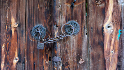The lock of an old wooden door. Vintage door.