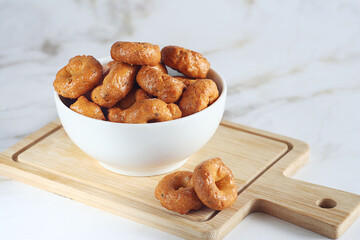 Italian crackers lie in a plate on a marble table. Vegetarian snack.