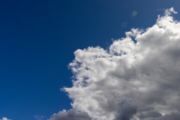 Naklejka na ściany i meble Blue sky with light clouds in windy weather