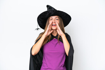 Young caucasian woman costume as witch isolated on white background shouting and announcing something