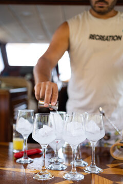 A man preparing cocktail with shaker. Summer holiday, party concept. No people face in photo.