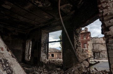 Plakat destroyed and burned houses in the city during the war in Ukraine