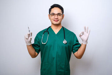 Pleasant smiling asian male doctor, physician wearing gloves and stethoscop doing okay gesture,...