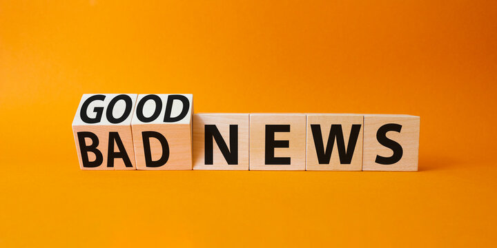 Good news and Bad news symbol. Turned wooden cubes with words Bad news and Good news. Beautiful orange background. Business concept. Copy space