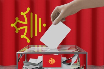 Occitanie flag, hand dropping ballot card into a box - voting/ election concept - 3D illustration